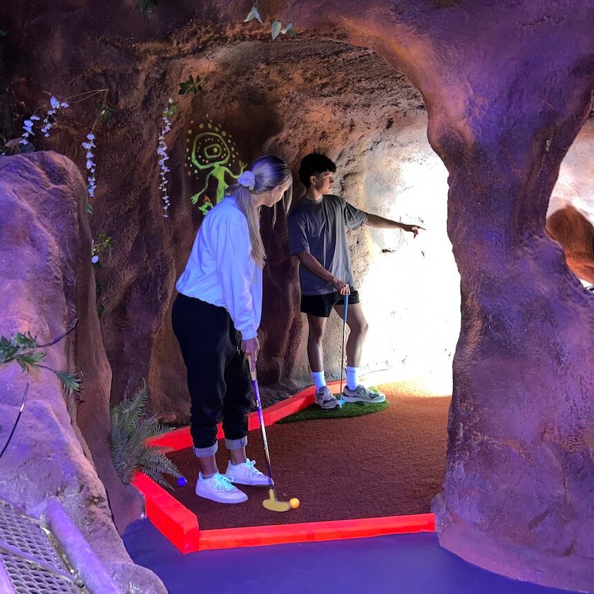 Teenagers play the iconic King Tutts indoor mini golf in Melbourne South-East.